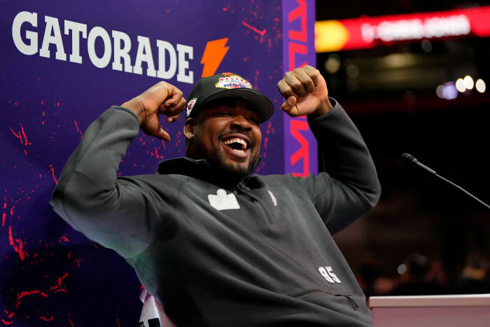 Chris Jones flexes his arms while smiling at the Super Bowl